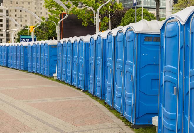 a fleet of portable restrooms ready for use at a large outdoor wedding or celebration in Cherry Hills Village